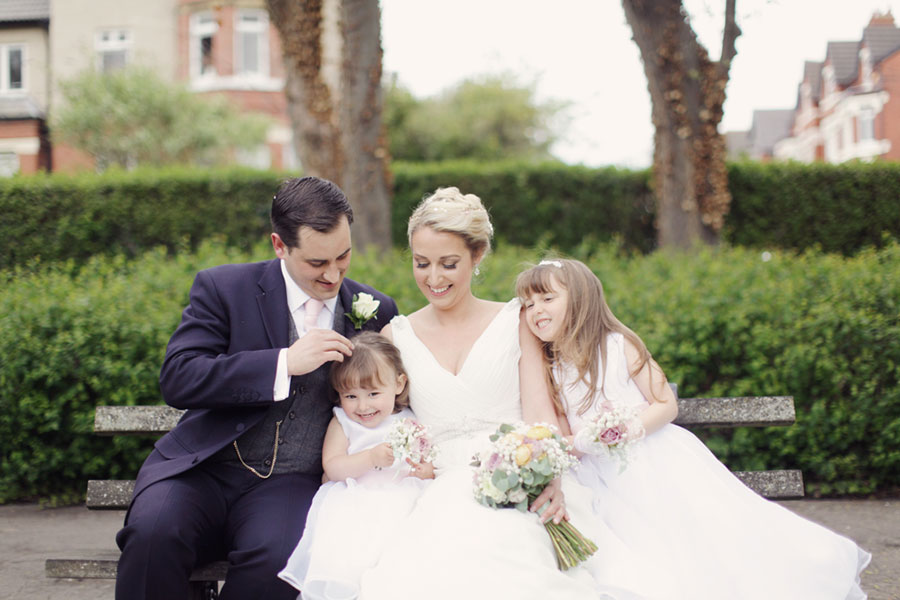 A beautiful family wedding photoshoot with two daughters at Ashton Park in West Kirby with natural wedding photography of family photoshoot ideas by Sasha Lee Photography