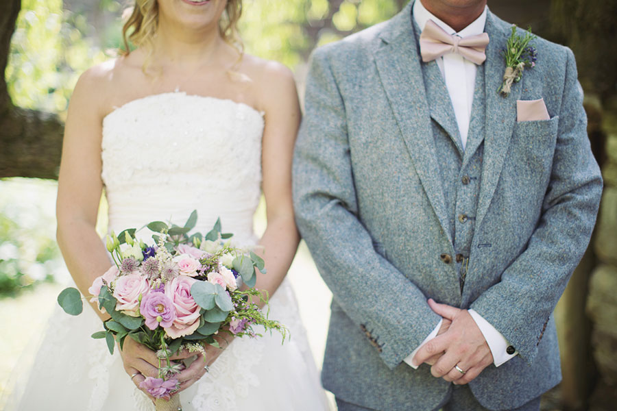 A crazy cool alternative and unique Thirsk York Yorkshire wedding venue The Crab & Lobster with natural wedding photography with a photo of the bride and groom standing side by side with grey and pink by Sasha Lee Photography