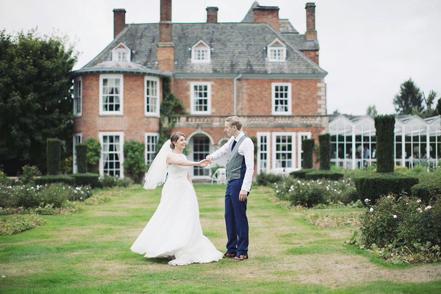 Yorkshire Leicestershire Loughborough wedding venue at Sutton Bonington Hall manor house with natural wedding photography of the husband and wife dancing outside